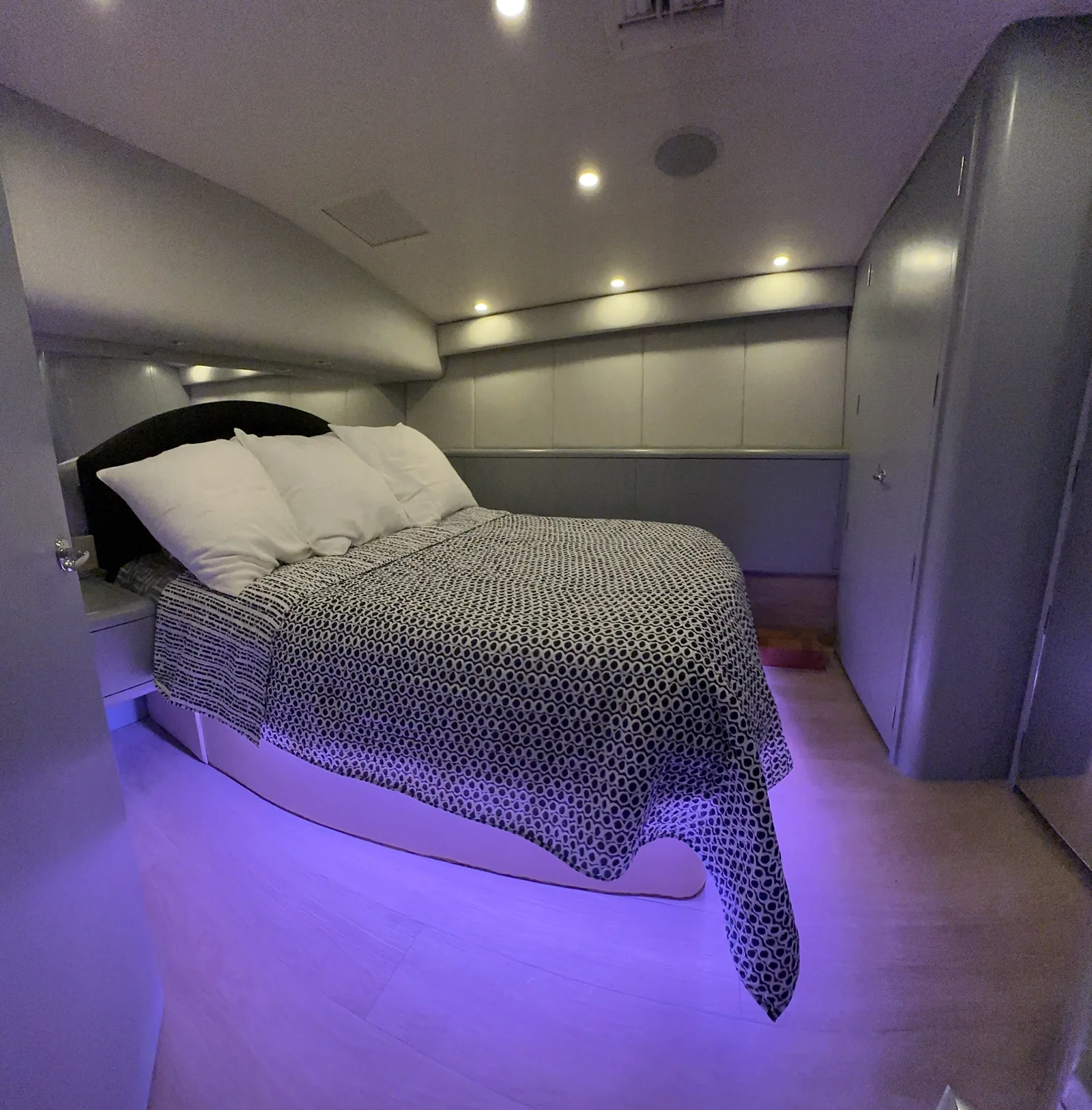 Master queen stateroom on Lion Heart 60ft Hatteras with purple under-bed lighting